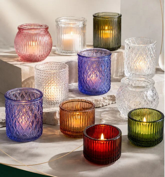 Colored embossed glass candle holders in multiple shapes and patterns