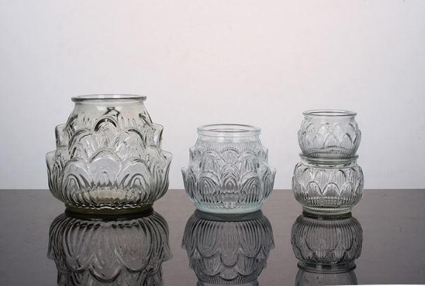 assorted embossed clear glass candle jars in multiple sizes