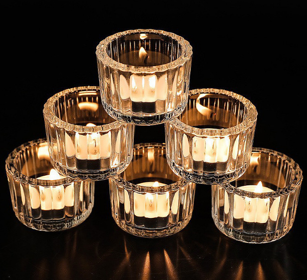 clear ribbed glass votive holders with lit candles