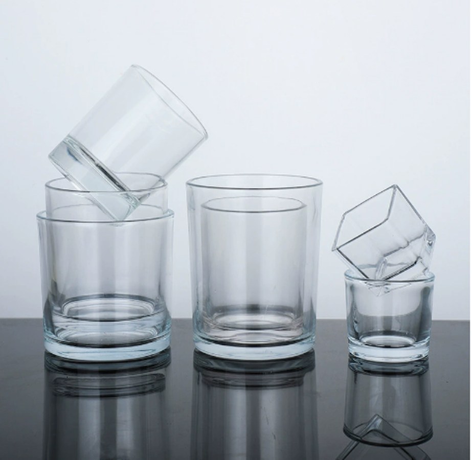 Thick-walled clear pressed glass tumblers, nested and stacked